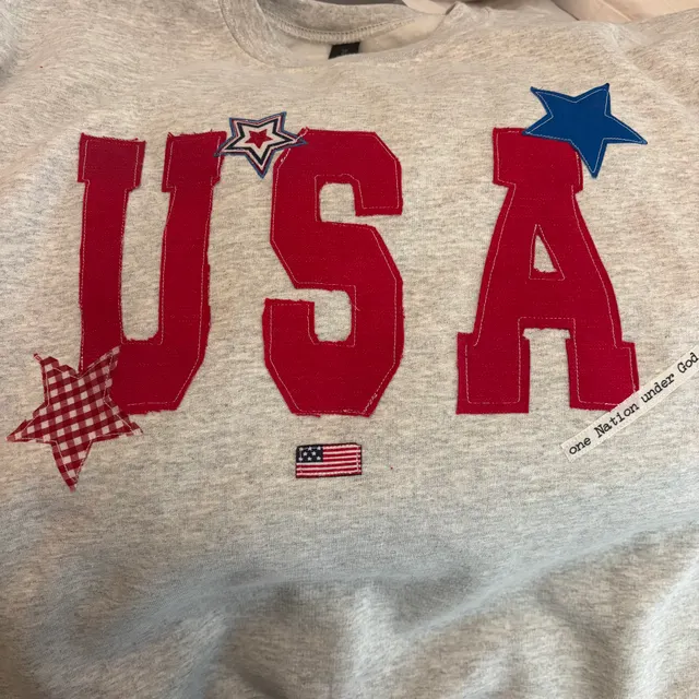 Light heather grey sweatshirt with large USA letters, stars and a small flag, reading one Nation under God