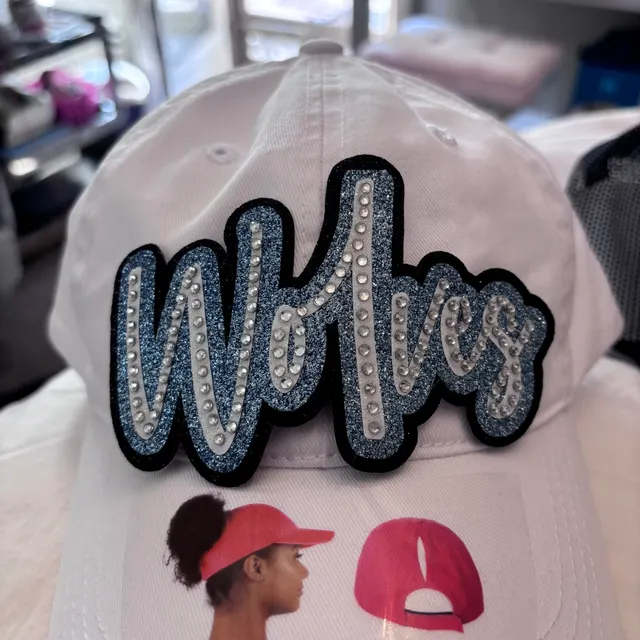 White ponytail cap with a Wolves glitter and rhinestone patch